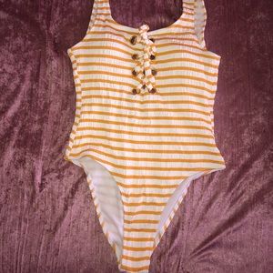 A yellow and white stripped bathing suit One piece